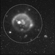 Image showing Io soon after it was eclipsed by Jupiter. The brightest spot is likely a penetrating radiation signature, while the other glowing regions show activity from several of Io’s volcanoes. The smaller circled image is the volcanic plume.